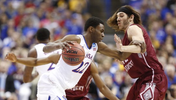 Kansas guard Andrew Wiggins drives around Eastern Kentucky forward Eric Stutz during the first half on Friday, March 21, 2014 at Scottrade Center in St. Louis.