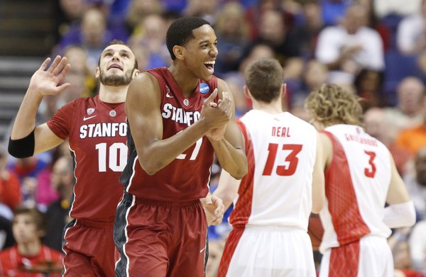 Stanford guard Anthony Brown, front, claps his hands after a New Mexico foul on Friday, March 21, 2014 at Scottrade Center in St. Louis. At left is Stanford guard Robbie Lemons.