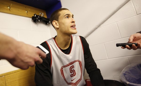 Stanford forward Dwight Powell, a Toronto native, talks with reporters about his familiarity with Kansas guard Andrew Wiggins, also from Toronto, in the team locker room on Saturday, March 22, 2014 at Scottrade Center in St. Louis.