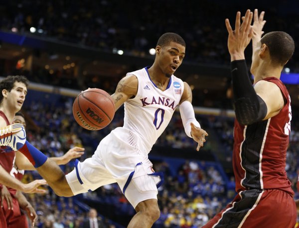 Kansas guard Frank Mason dumps a pass inside against Stanford during the first half on Sunday, March 23, 2014 at Scottrade Center in St. Louis.