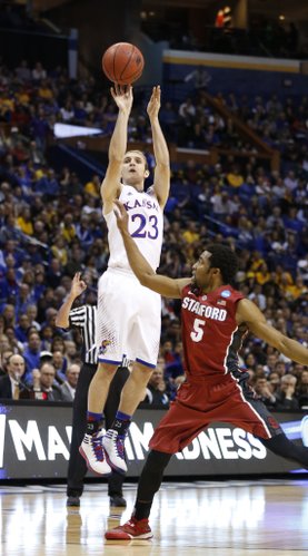 Kansas guard Conner Frankamp puts a three over Stanford guard Chasson Randle during the first half on Sunday, March 23, 2014 at Scottrade Center in St. Louis.