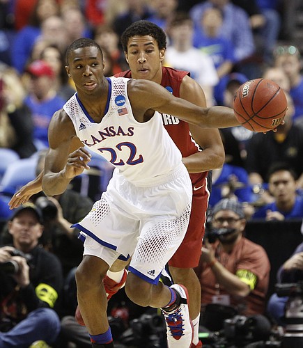 Kansas guard Andrew Wiggins heads up the court past Stanford forward Josh Huestis during the first half on Sunday, March 23, 2014 at Scottrade Center in St. Louis.