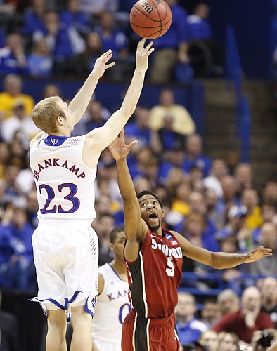 Kansas guard Conner Frankamp puts up a three over Stanford guard Chasson Randle to get the Jayhawks within two points with less than a minute remaining on Sunday, March 23, 2014 at Scottrade Center in St. Louis.