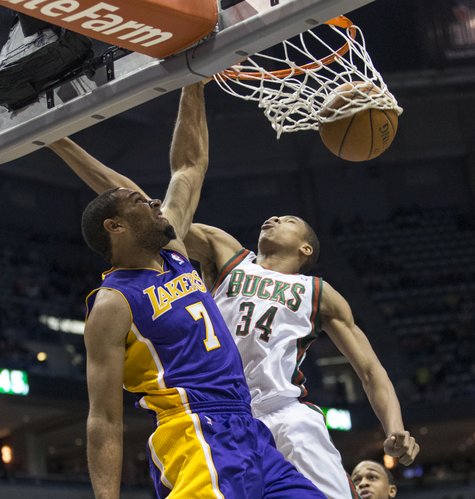 Milwaukee Bucks' Giannis Antetokounmpo can not stop Los Angeles Lakers' Xavier Henry from dunking the ball during the first half of an NBA basketball game Thursday, March 27, 2014, in Milwaukee. (AP Photo/Tom Lynn)