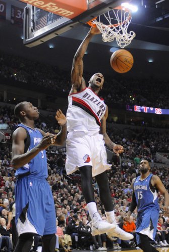 Portland Trail Blazers' Thomas Robinson (41) scores against Minnesota Timberwolves' Gorgui Dieng (5) during the second half of an NBA basketball game in Portland, Ore., Sunday, Feb. 23, 2014. The Trail Blazers won 108-97. (AP Photo/Greg Wahl-Stephens)