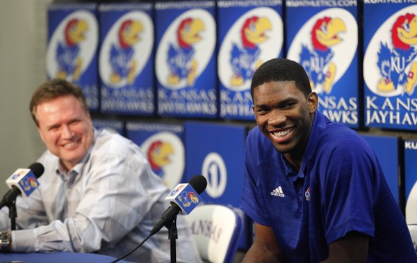 Kansas center Joel Embiid smiles along side head basketball coach Bill Self as he talks with media members during a news conference on Wednesday, April 9, 2014 at Allen Fieldhouse in Lawrence, Kan. Embiid announced his intention to enter the 2014 NBA Draft. (AP PHOTO/Nick Krug/Lawrence Journal-World)