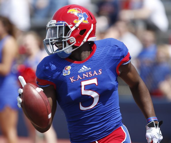 Blue Team safety Isaiah Johnson flashes a smile after intercepting White Team quarterback Michael Cummings during the first half of the Kansas Spring Game on Saturday, April 12, 2014 at Memorial Stadium. Nick Krug/Journal-World Photo