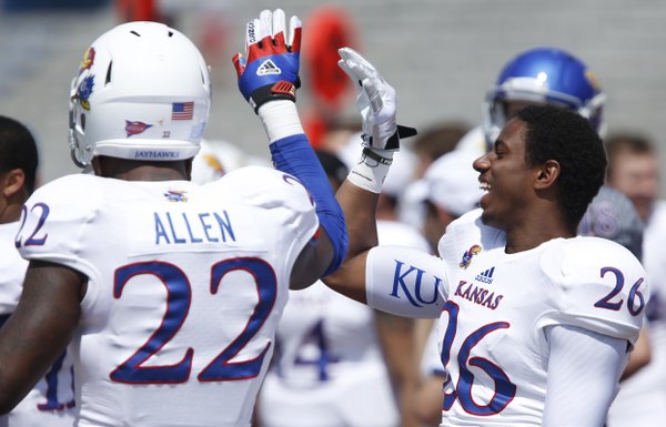 White Team defenders Greg Allen and Brandon Hollomon celebrate a stop by the White Team during the first half of the Kansas Spring Game on Saturday, April 12, 2014 at Memorial Stadium. Nick Krug/Journal-World Photo