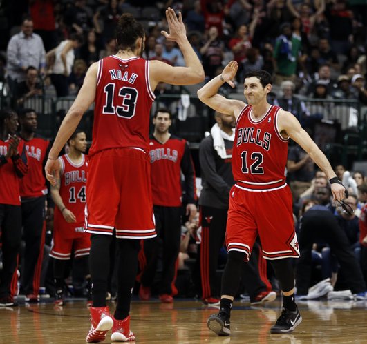 Chicago Bulls center Joakim Noah (13) and guard Kirk Hinrich (12) celebrate at the end of the team's 100-91 comeback win over the Dallas Mavericks in an NBA basketball game on Friday, Feb. 28, 2014, in Dallas. (AP Photo/John F. Rhodes)