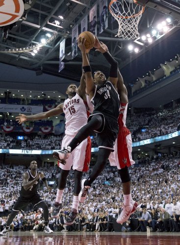 Brooklyn Nets forward Paul Pierce (34) drives to the basket against Toronto Raptors forward Amir Johnson (15) during the second half of Game 2 in an NBA basketball first-round playoff series, Tuesday, April 22, 2014, in Toronto. Toronto won 100-95. (AP Photo/The Canadian Press, Frank Gunn)