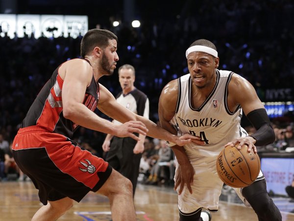 Toronto Raptors' Greivis Vasquez defends Brooklyn Nets' Paul Pierce (34) during the second half of Game 3 of an NBA basketball first-round playoff series Friday, April 25, 2014, in New York. The Nets won 102-98. (AP Photo/Frank Franklin II)