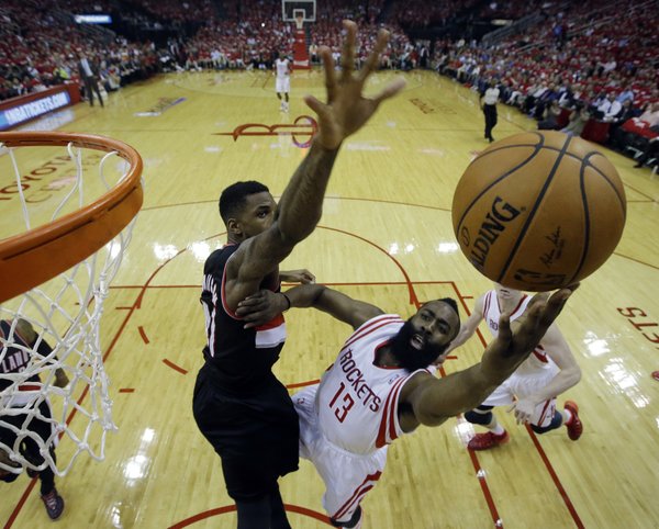 Houston Rockets' James Harden (13) put sup a shot against Portland Trail Blazers' Thomas Robinson (41) during the first half in Game 2 of an opening-round NBA basketball playoff series Wednesday, April 23, 2014, in Houston. (AP Photo/David J. Phillip)