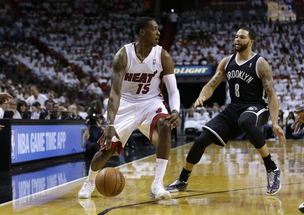Miami Heat's Mario Chalmers (15) drives to the basket as Brooklyn Nets' Deron Williams (8) defends in the first half of Game 1 in an Eastern Conference semifinal basketball game, Tuesday, May 6, 2014, in Miami. (AP Photo/Lynne Sladky)