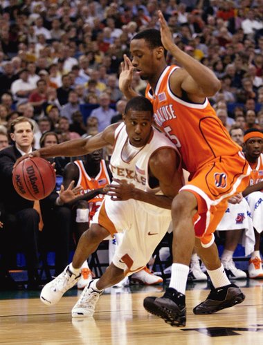 Texas' T.J. Ford drives on Syracuse's Josh Pace in the first half of a semifinal game of the Final Four on Saturday, April 5, 2003, in New Orleans. (AP Photo/Michael Conroy)