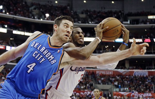 Oklahoma City Thunder forward Nick Collison (4) and Los Angeles Clippers guard Chris Paul (3) tangle in the second half of an NBA basketball game in Los Angeles, Sunday, March 3, 2013. The Thunder won 108-104. (AP Photo/Reed Saxon)