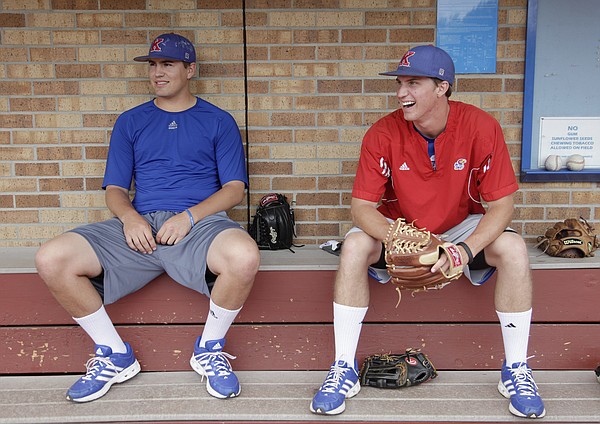 Senior pitchers Frank Duncan, left, and Jordan Piché relax before practice shortly after the Jayhawks found out they made it into the NCAA Tournament and will play University of Kentucky in Louisville, Kentucky, on Friday, May 30, 2014.
