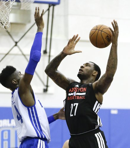 Houston Rockets’ Tarik Black, right, tries to shoot over Philadelphia 76ers’ Nerlens Noel in an NBA summer-league game, Tuesday, July 8, 2014, in Orlando, Florida.