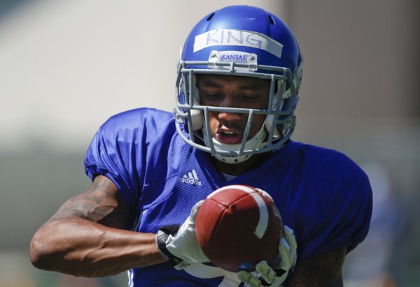 Kansas receiver Nigel King catches a pass during practice on Tuesday, Aug. 12, 2014.