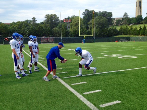 Safeties coach Scott Vestal works with SS Isaiah Johnson during a drill at Friday's morning practice. 