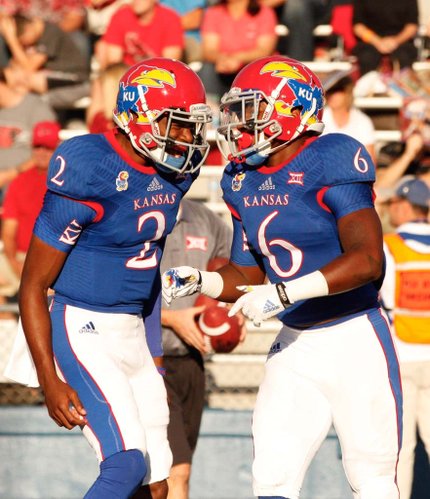 Kansas quarterback Montell Cozart celebrates a touchdown by running back Corey Avery against Southeast Missouri State during the first quarter on Saturday, Sept. 6, 2014 at Memorial Stadium.