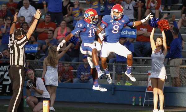 Kansas receivers Justin McCay (19) and Nick Harwell (8) celebrate Harwell's first touchdown of the game against Southeast Missouri State during the first quarter on Saturday, Sept. 6, 2014 at Memorial Stadium.