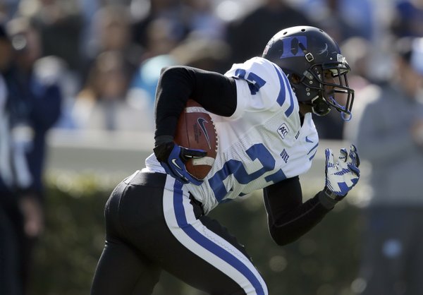 Duke's DeVon Edwards (27) runs against North Carolina during the first half of an NCAA college football game in Chapel Hill, N.C., Saturday, Nov. 30, 2013. (AP Photo/Gerry Broome)
