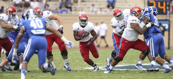 Kansas running back De'Andre Mann finds a hole against Duke during the second quarter on Saturday, Sept. 13, 2013 at Wallace Wade Stadium in Durham, North Carolina.