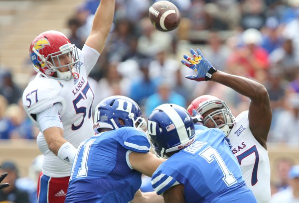 Kansas defenders Jake Love (57) and Victor Simmons can't stop a throw from Duke quarterback Anthony Boone during the first quarter on Saturday, Sept. 13, 2013 at Wallace Wade Stadium in Durham, North Carolina.