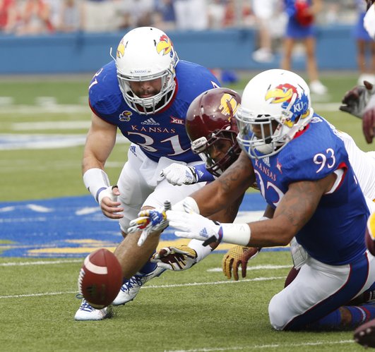 From left, KU Senior Ben Heeney (31) and junior Ben Goodman (93) go after a fumble against Central Michigan's Anthony Garland (44) on Saturday, September 20, 2014 at Memorial Stadium.