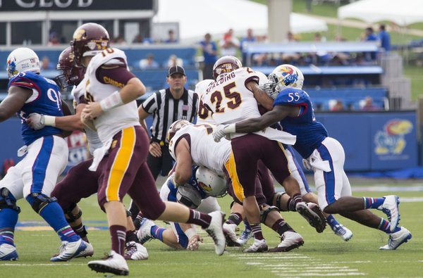 Kansas senior Michael Reynolds (55) pulls down Central Michigan running back Devon Spalding (25) for a loss during their game on Saturday afternoon at Memorial Stadium. 
