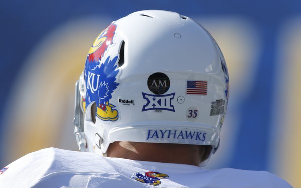 On the back of the Jayhawks' helmets are the initials AM to represent Andre Maloney, a Kansas recruit from Shawnee Mission West High School who died after suffering a stroke on the field on Oct. 4, 2013.