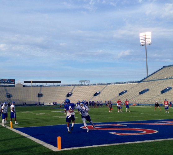 KU receiver Nick Harwell and defensive back Greg Allen battle for a ball during Wednesday's one-on-ones. 