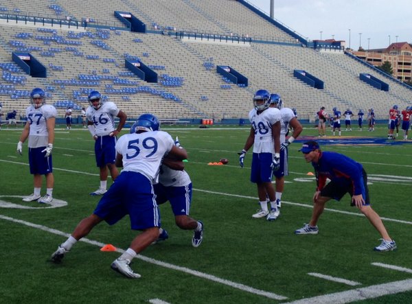 KU coach Clint Bowen sticks his head into a drill featuring KU's linebackers during Wednesday's practice. 