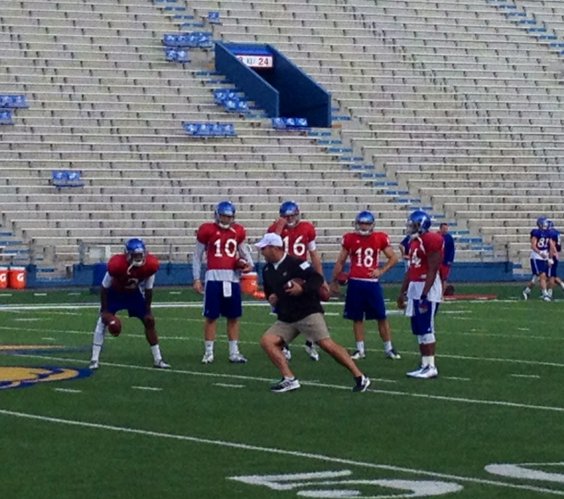 KU quarterbacks coach Ron Powlus works with the Kansas quarterbacks during Wednesday's practice. 