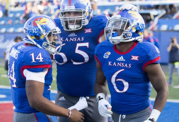 Kansas players Corey Avery (6), Mike Smithburg (65) and Michael Cummings (14) celebrate Avery's fourth quarter touchdown during their game against Oklahoma State Saturday afternoon at Memorial Stadium.