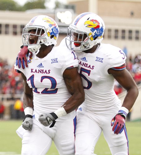 Kansas safety Isaiah Johnson (5) encourages teammate Dexter McDonald after McDonald bobbled a would-be interception against Texas Tech during the first quarter on Saturday, Oct. 18, 2014 at Jones AT&T Stadium in Lubbock, Texas. The Red Raiders scored on the ensuing drive.