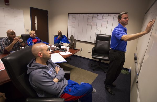 Kansas interim head football coach Clint Bowen works through a defensive plan for Baylor with coaches Scott Vestal, front, Ty Greenwood, Dave Campo and Buddy Wyatt on Wednesday, Oct. 22, 2014.