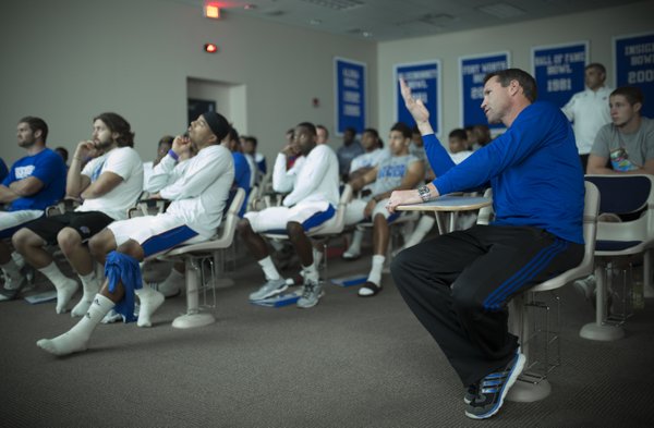 Kansas head football coach Clint Bowen gives his opinion as he and members of the special teams unit watch game film on Wednesday, Oct. 22, 2014.