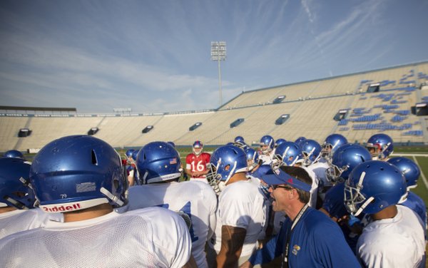Kansas interim head football coach Clint Bowen gets fired up with the team as they come together on the field before practice on Wednesday, Oct. 22, 2014.