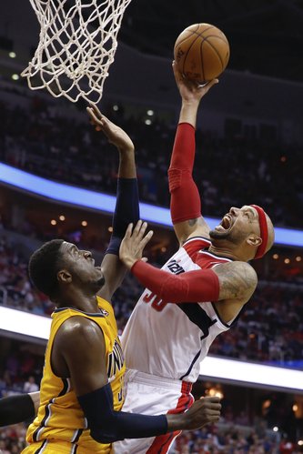 Washington Wizards forward Drew Gooden , right, shoots past Indiana Pacers center Roy Hibbert during the first half of Game 4 of an Eastern Conference semifinal NBA basketball playoff game in Washington, Sunday, May 11, 2014. (AP Photo/Alex Brandon)
