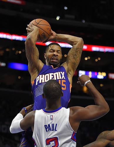 Phoenix Suns forward Marcus Morris, top, grabs a rebound away from Los Angeles Clippers guard Chris Paul during the first half of a preseason NBA basketball game, Wednesday, Oct. 22, 2014, in Los Angeles. (AP Photo/Mark J. Terrill)
