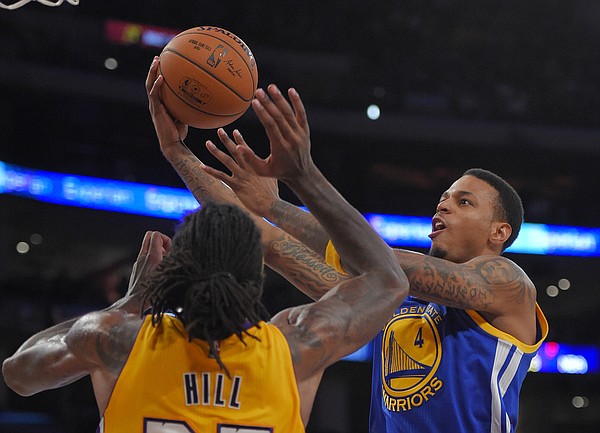 Golden State Warriors guard Brandon Rush, right, puts up a shot as Los Angeles Lakers forward Jordan Hill defends during the second half of a preseason basketball game, Thursday, Oct. 9, 2014, in Los Angeles. (AP Photo/Mark J. Terrill)
