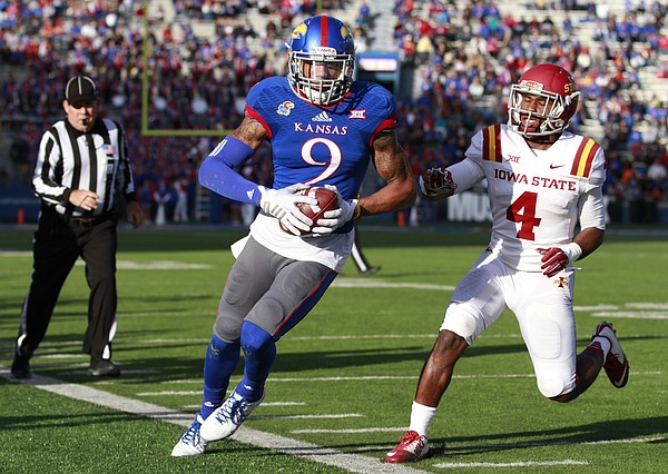 Kansas receiver Nigel King is forced out of bounds after a catch against Iowa State defensive back Sam Richardson during the second quarter on Saturday, Nov. 8, 2014.