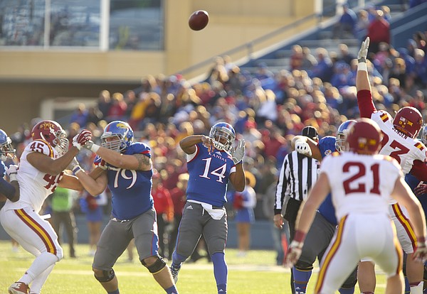 Kansas quarterback Michael Cummings heaves a pass over the Iowa State defense during the first quarter on Saturday, Nov. 8, 2014.