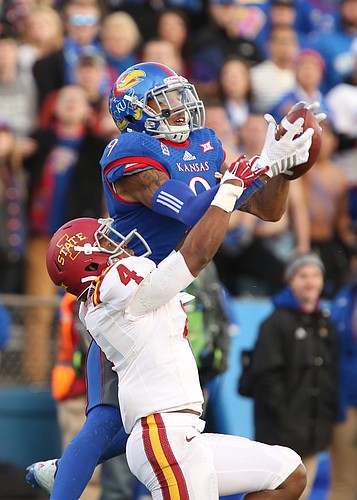 Kansas receiver Nigel King gets high over Iowa State defensive back Sam Richardson for a deep catch during the third quarter on Saturday, Nov. 8, 2014.