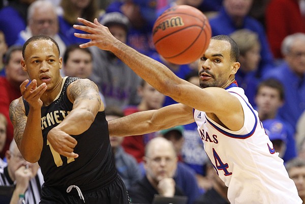 Kansas forward Perry Ellis defends against a pass from Emporia State guard Terrence Moore during the first half on Tuesday, Nov. 11, 2014.