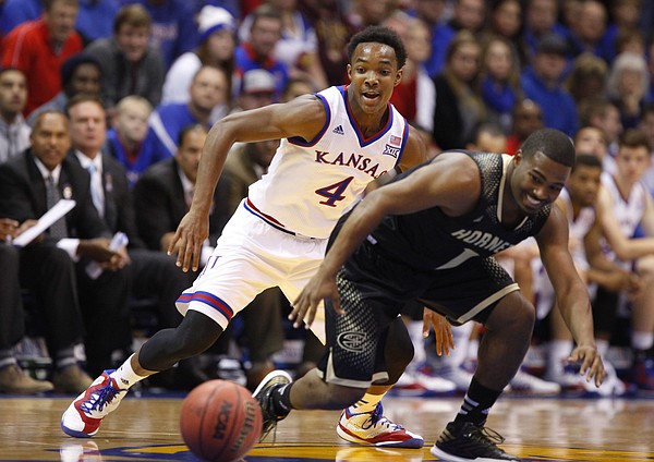 Kansas guard Devonte Graham gets wide-eyed as he chases a ball knocked away from Emporia State guard Perryonte Smith during the first half on Tuesday, Nov. 11, 2014.
