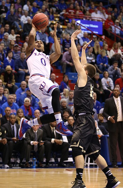 Kansas guard Frank Mason pulls up for a shot after a foul from Emporia State guard Micah Swank during the first half on Tuesday, Nov. 11, 2014.