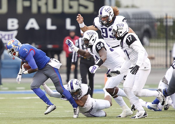 Kansas running back Tony Pierson looks to break away from a herd of TCU defenders during the first quarter on Saturday, Nov. 15, 2014 at Memorial Stadium.