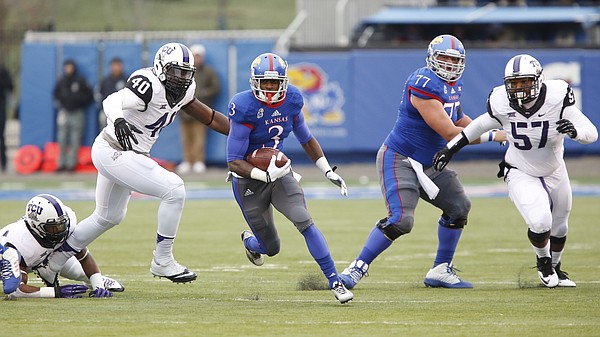 Kansas running back Tony Pierson finds a hole as he heads up the field for a first down against TCU during the first quarter on Saturday, Nov. 15, 2014 at Memorial Stadium.